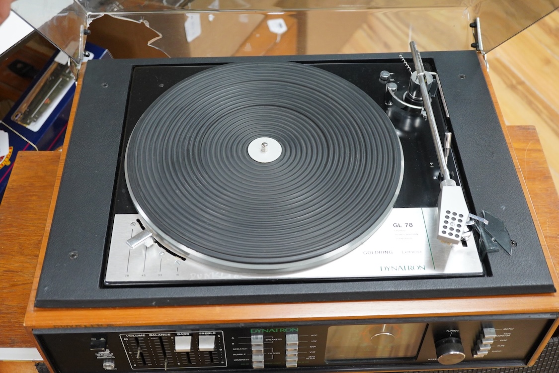 A Dynatron Goldring GL78 turntable with integral amplifier and tuner, made in Switzerland, together with a pair of Leak Sandwich 600 stereo speakers in teak cabinets, 65cm high